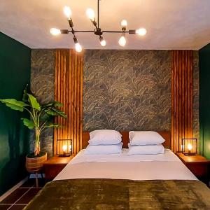 a bedroom with a large bed with two pillows at Atelier Skalo Boutique Hotel in Willemstad