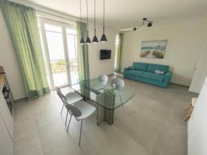 a living room with a glass table and chairs at Podere Belvedere in Moneglia