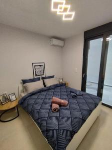 a bedroom with a large bed with two towels on it at Brand new flat with courtyard and private parking! in Athens