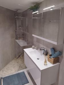 a white bathroom with a sink and a mirror at Brand new flat with courtyard and private parking! in Athens