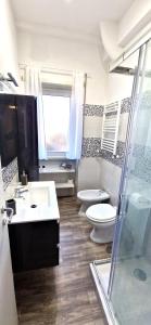 a bathroom with a toilet and a sink and a shower at Il centro di Ostia (apartment) in Lido di Ostia