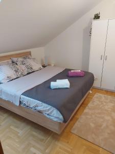 a bedroom with a bed with two towels on it at Apartman Panorama in Požarevac
