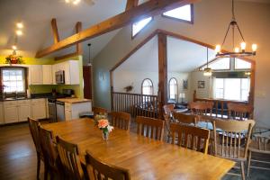 a dining room and kitchen with a wooden table and chairs at The Maples - Hot tub! Amazing views, pets welcomed in Ellicottville