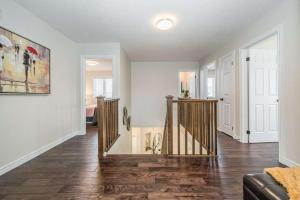 a living room with a staircase in a house at Comfortable Modern Room near YKF Airport III in Kitchener