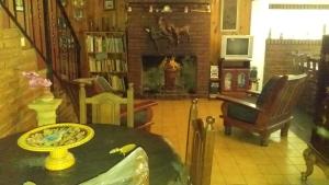 a living room with a table and a fireplace at Quinta Don Diego in Piñero