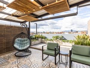 a patio with two chairs and a swing at Life by Wynwood House in Bogotá