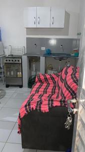 Cama o camas de una habitación en Kitinete Aconchegante