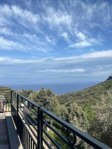 a balcony with a view of a hill with trees at Villa de charme vue mer in Brando