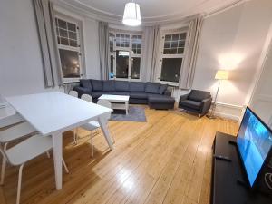 a living room with a white table and a couch at Home Inn SVG108 in Stockholm