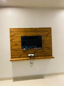 a flat screen tv on a wall at New Hotel Amber International Near International Airport T2 in Mumbai