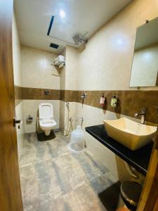a bathroom with a sink and a toilet at New Hotel Amber International Near International Airport T2 in Mumbai