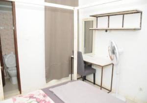 a bathroom with a desk and a chair and a toilet at Résidence Doux in Dakar