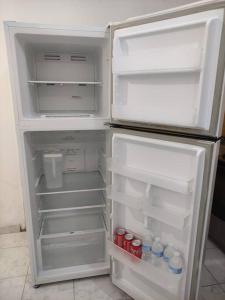 an open refrigerator with its door open and drinks inside at Apartamento cozy casco in Panama City