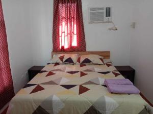 a bedroom with a bed with a quilt on it at Kate Residence House in Dao +20 photos