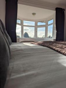 a bedroom with a large bed with a large window at The Moorhead Bed & Breakfast in Wem