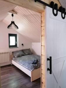 a small bedroom with a bed in a room at Domek Zielony Widok - noclegi Bieszczady in Lesko
