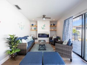 a living room with a blue couch and chairs at Venice 3 Bedroom Luxury Home, Completely Renovated, 5 Star Rated - 10Mins to Beaches in Venice
