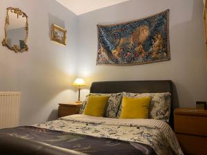 a bedroom with a bed with a tapestry on the wall at Beautifully unique town centre apartment in Macclesfield