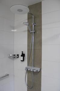 a shower with a glass door in a bathroom at Motel Hasetal in Löningen