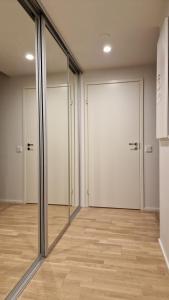 an empty room with glass doors and wooden floors at Silent apartment with balcony in Turku