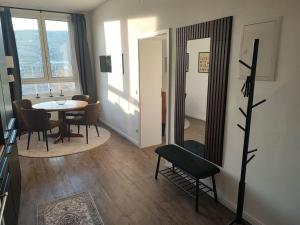 a dining room with a table and chairs and a mirror at Modernes Juwel in Hagen City in Hagen