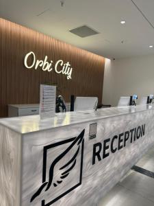 an office reception counter with a sign on it at Orbi city - Premium Class Rooms in Batumi