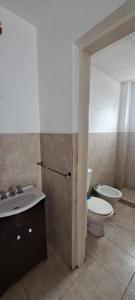 a bathroom with a toilet and a sink at Alto Bustamante in San Salvador de Jujuy