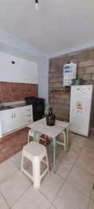 a kitchen with a table and chairs and a refrigerator at Alto Bustamante in San Salvador de Jujuy