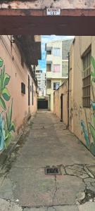 an empty alley with graffiti on the side of a building at Alto Bustamante in San Salvador de Jujuy