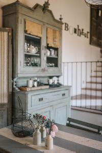 a kitchen with a hutch and flowers on a table at B&B Giarola 25.2 in Cittanova