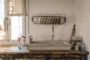 a bathroom with a stone tub on a wooden table at B&B Giarola 25.2 in Cittanova