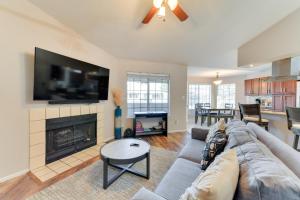 a living room with a couch and a fireplace at Pet-Friendly Condo with Pool about 7 Mi to Dtwn Chandler in Chandler