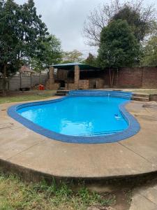 a large swimming pool in a yard at PMB Backpackers Lodge in Pietermaritzburg