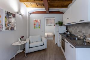 a kitchen with a sink and a chair in a room at La Casa di Enrichetta - Pavia City - by HOST4U in Pavia