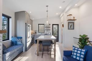 a kitchen and living room with a table and chairs at Ocean View Townhouse #26 at THE BEACH HOUSE in Campbell River