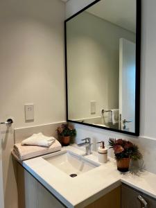 a bathroom with a sink and a large mirror at Brand New 1BHK Near Burj Khalifa-Burj Crown tower in Dubai