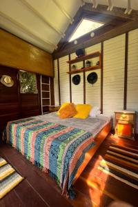 1 dormitorio con 1 cama con una manta colorida en La Aldea Ruitoque, en Floridablanca