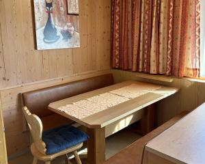 a table in a room with a bench and a table and a chair at Ferienhaus Frühlingsheim in Sölden