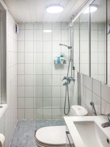a bathroom with a shower and a toilet and a sink at Villa Primavera Apartment in Hanko in Hanko