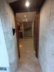 a hallway of a building with a staircase and a door at Casa 42 in Monção