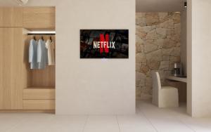 a living room with a wall with a poster on it at Haus Platanos Apartments & Bungalows by the Sea in Vourvourou