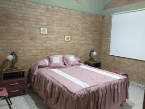 a bedroom with a bed and a projection screen at VALLE GRANDE - CASA ARAUCARIA - SOLAR DEL VALLE in Valle Grande +31 photos