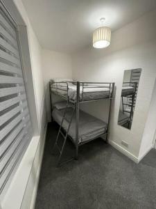 a room with two bunk beds and a mirror at 212a bell lane in Bury