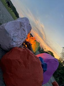 a group of colorful rocks sitting next to a fire at wellgaya ecovillas in Villa Flor