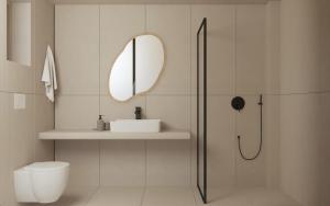 a white bathroom with a sink and a shower at Haus Platanos Apartments & Bungalows by the Sea in Vourvourou