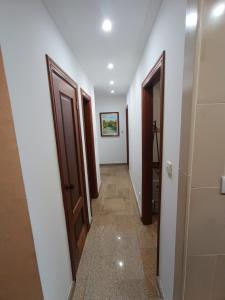 a hallway with two doors and a tile floor at Casa 42 in Monção