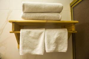 two towels on a wooden shelf in a bathroom at Plaza Mayor Lima in Lima