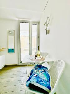 a table and a chair with a bag on it at AMBER APARTMENTS - SUNNY STUDIO in Morro del Jable