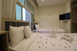 a hotel room with two beds with confetti on them at Loca Pyramids View in Cairo