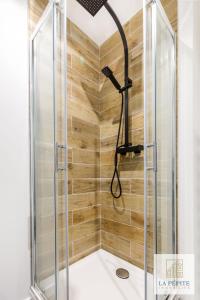 a shower with a shower head in a bathroom at Residence Belle Etoile in Valenciennes